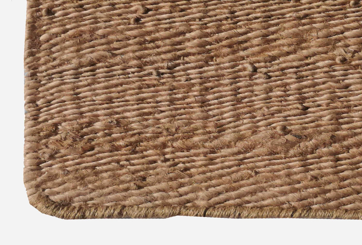 Textura natural del yute en alfombra importada, tacto orgánico