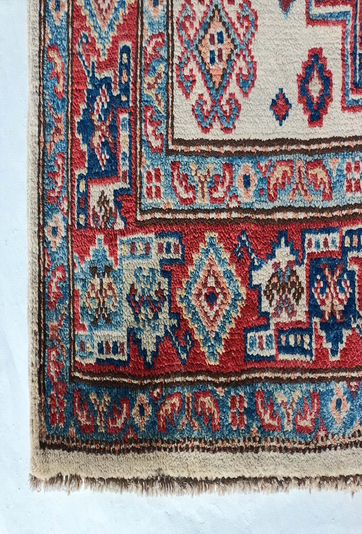Textura suave y gruesa de lana natural en alfombra persa Kazak