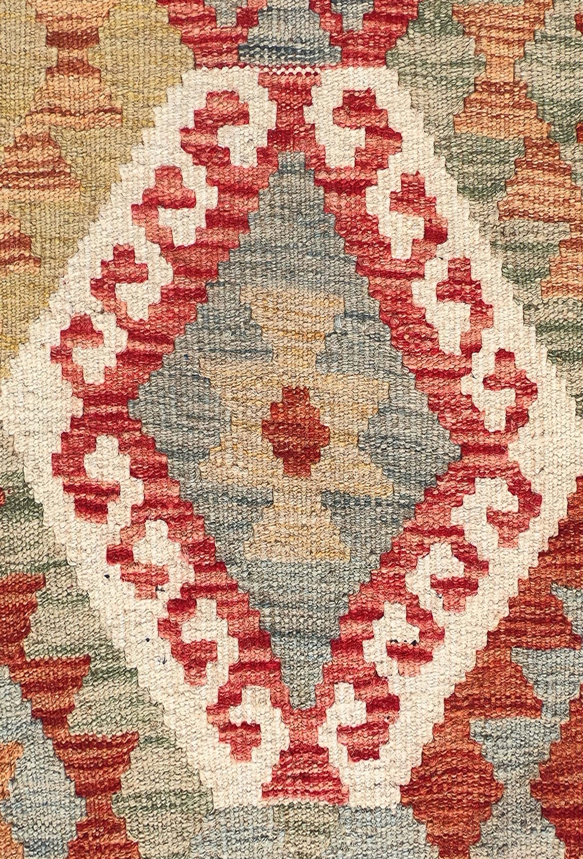 Detalle de motivos geométricos en alfombra Kelim de lana con tintes naturales