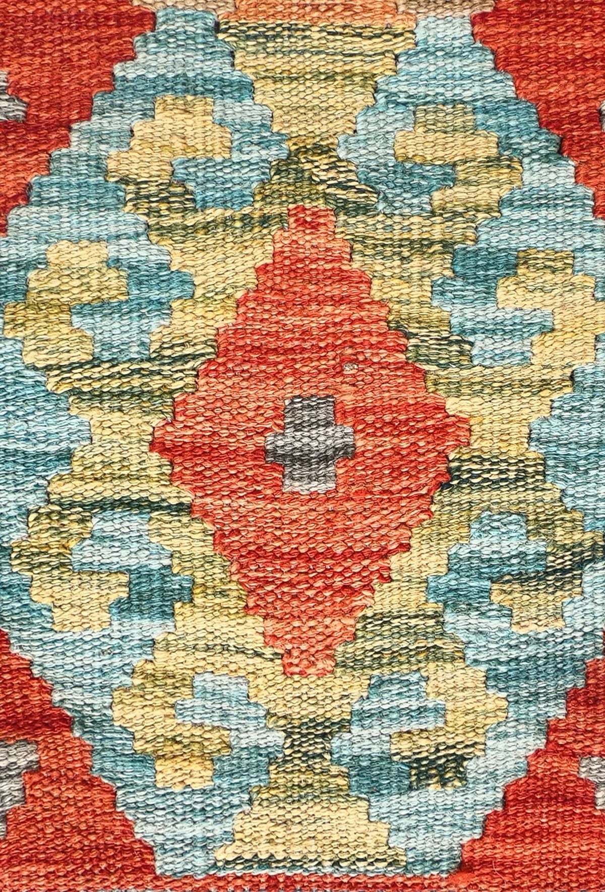 Detalle de motivos geométricos en alfombra kelim de lana, tejido plano