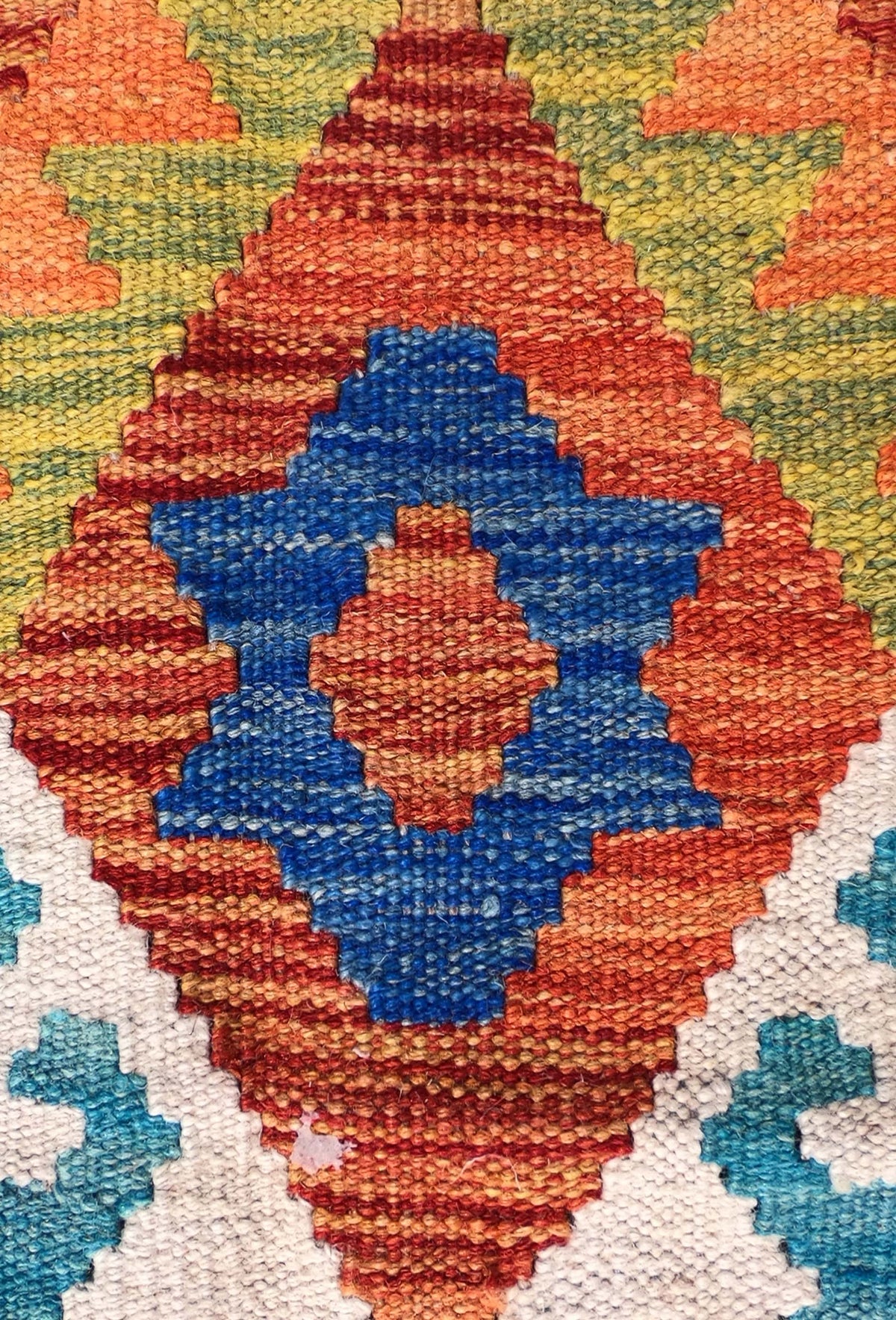Detalle de motivos geométricos en alfombra Kelim de lana tejida a mano