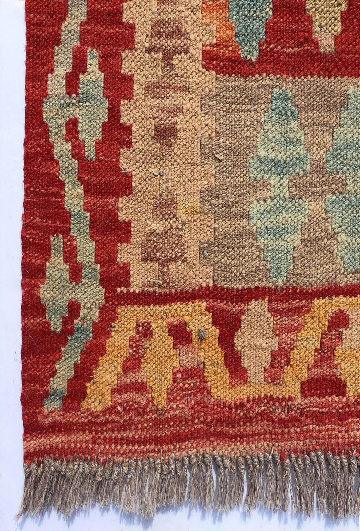 Textura de lana natural en alfombra Kelim hecha a mano con tintes orgánicos