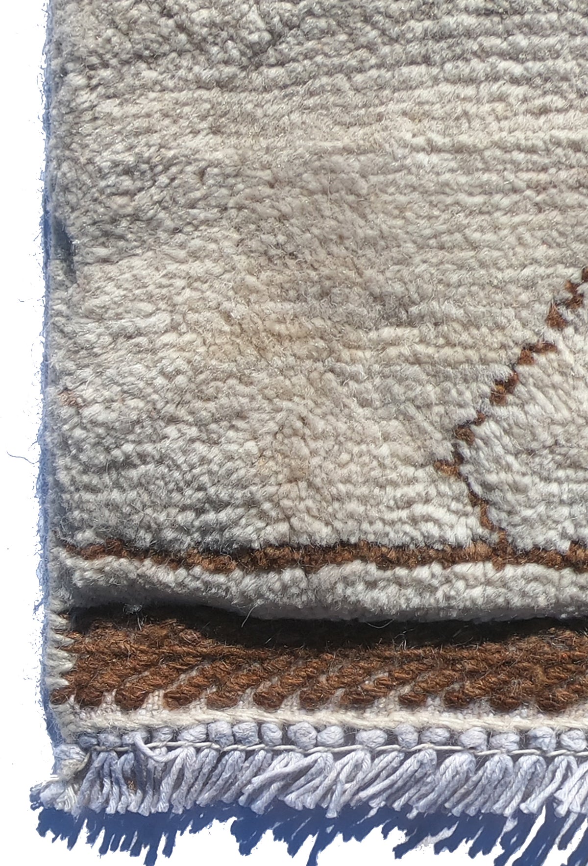 Textura de lana natural en alfombra hecha a mano para living